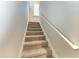 Carpeted staircase with a white handrail leading to the upper level at 303 Cockle Shell Loop, Apollo Beach, FL 33572