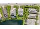 A beautiful view of a house surrounded by green grass near a tranquil lake at 3344 Anchor Bay Trl, Bradenton, FL 34211