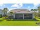 Manicured backyard featuring a screened-in patio and lush green lawn, perfect for entertaining and outdoor activities at 3344 Anchor Bay Trl, Bradenton, FL 34211