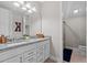 Bright bathroom featuring dual sinks with stone countertops and white cabinets, offering style and functionality at 3344 Anchor Bay Trl, Bradenton, FL 34211
