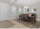Formal dining room featuring a modern chandelier, shutters, and seating for six at 3344 Anchor Bay Trl, Bradenton, FL 34211