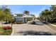 Community entry gate with beautiful landscaping and well-maintained street in a tropical neighborhood at 3344 Anchor Bay Trl, Bradenton, FL 34211