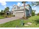 Beautifully landscaped home with a brick driveway and a two-car garage, set against a blue sky at 3344 Anchor Bay Trl, Bradenton, FL 34211