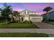 Charming two-story home with a manicured lawn, inviting entrance, and attached two-car garage at 3344 Anchor Bay Trl, Bradenton, FL 34211