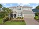 Charming two-story home with a landscaped front yard and inviting curb appeal, perfect for a Gathering at 3344 Anchor Bay Trl, Bradenton, FL 34211