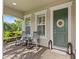 Inviting front porch with rocking chairs and a decorative wreath on the door at 3344 Anchor Bay Trl, Bradenton, FL 34211