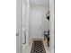 Clean hallway with stylish bench and storage, leading to the laundry room at 3344 Anchor Bay Trl, Bradenton, FL 34211