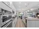 Bright, modern kitchen with stainless appliances, granite countertops, large island, and scenic lake views at 3344 Anchor Bay Trl, Bradenton, FL 34211