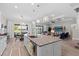 Open-concept kitchen with granite island, pendant lighting, flows seamlessly to dining & living areas at 3344 Anchor Bay Trl, Bradenton, FL 34211