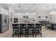 Large kitchen island boasts seating, granite countertop, and stainless steel appliances for a functional space at 3344 Anchor Bay Trl, Bradenton, FL 34211