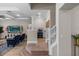 Open-concept living area with staircase, light wood floors, and modern decor at 3344 Anchor Bay Trl, Bradenton, FL 34211
