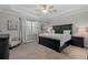 Comfortable main bedroom with tray ceiling, neutral tones, blackout curtains and generous natural light at 3344 Anchor Bay Trl, Bradenton, FL 34211