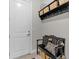 Welcoming mudroom featuring a storage bench with pillows and woven baskets, and coat hooks for organization at 3344 Anchor Bay Trl, Bradenton, FL 34211