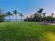 Sprawling lawn leading to waterfront, lined with palm trees at 355 Shore Dr, Ellenton, FL 34222