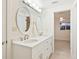 Elegant bathroom with double sinks, granite countertop, and oval mirrors at 355 Shore Dr, Ellenton, FL 34222