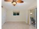 The bedroom features neutral tile floors, a ceiling fan, and a sliding glass door to an outdoor patio at 355 Shore Dr, Ellenton, FL 34222