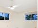 Bedroom with light walls, two windows, and ceiling fan at 355 Shore Dr, Ellenton, FL 34222