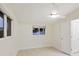 Bright bedroom featuring ceiling fan, two windows, and base molding at 355 Shore Dr, Ellenton, FL 34222