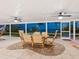 Enclosed patio with waterfront views, ceiling fans, and a dining table at 355 Shore Dr, Ellenton, FL 34222