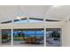 Covered patio with tile flooring, ceiling fans, and views of the water at 355 Shore Dr, Ellenton, FL 34222