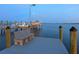 Private boat dock on the water, featuring a bench and boat lift at 355 Shore Dr, Ellenton, FL 34222