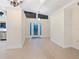 Inviting entryway with tile floors, a decorative light fixture, and a glass-paneled front door at 355 Shore Dr, Ellenton, FL 34222