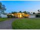 Charming one-story home featuring a circular driveway, a covered carport and landscaped yard at 355 Shore Dr, Ellenton, FL 34222