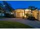 Home exterior featuring a covered entryway, manicured lawn, and inviting curb appeal with a concrete driveway at 355 Shore Dr, Ellenton, FL 34222