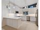 Bright kitchen with stainless steel appliances, white cabinetry, and a view of the backyard at 355 Shore Dr, Ellenton, FL 34222