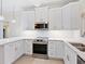 Bright kitchen with stainless steel appliances, white cabinets and stone countertops at 355 Shore Dr, Ellenton, FL 34222