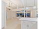 Bright living area overlooking a waterway, with modern light fixtures and tile flooring at 355 Shore Dr, Ellenton, FL 34222