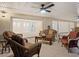 Inviting covered patio with tile flooring, comfortable seating, and a ceiling fan for relaxation and entertaining at 355 Shore Dr, Ellenton, FL 34222