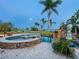 Resort-style pool and spa with waterfall feature, lush landscaping, and inviting ambiance at 355 Shore Dr, Ellenton, FL 34222