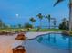 Luxury backyard pool with waterfront views and lounge seating at 355 Shore Dr, Ellenton, FL 34222