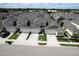 Aerial view shows the layout of the townhomes and manicured lawns in a well-planned neighborhood at 3681 Divot Ln, Sarasota, FL 34232