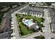 Aerial view of the community pool with cabanas, palm trees, lush landscaping and plenty of lounge chairs at 3681 Divot Ln, Sarasota, FL 34232