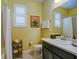 Bright bathroom featuring a single sink vanity and a shower with white curtain at 3681 Divot Ln, Sarasota, FL 34232