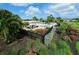 This luxurious community pool boasts ample lounging areas, a pergola, and beautiful tropical landscaping at 3681 Divot Ln, Sarasota, FL 34232