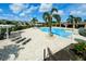 The community pool is beautifully landscaped with tropical palm trees and colorful flowers at 3681 Divot Ln, Sarasota, FL 34232