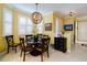 Cozy dining area with a pendant light fixture, plantation shutters, and a view of the open-concept kitchen at 3681 Divot Ln, Sarasota, FL 34232