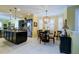 Open-concept design showcasing the dining area with chandelier, leading into the kitchen with modern appliances at 3681 Divot Ln, Sarasota, FL 34232
