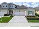 Home exterior features a two-car garage, paver driveway, manicured lawn and low maintenance landscaping at 3681 Divot Ln, Sarasota, FL 34232