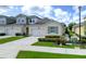 Inviting exterior of a charming home with a two-car garage, lush landscaping, and a well-maintained lawn at 3681 Divot Ln, Sarasota, FL 34232