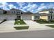 Well-kept exterior featuring a paver driveway, two-car garage and low maintenance landscaping at 3681 Divot Ln, Sarasota, FL 34232