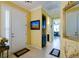 Warm foyer featuring tile floors, a white front door, and a glimpse into the home's stylish interiors at 3681 Divot Ln, Sarasota, FL 34232