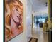 Hallway with tile flooring leading to a bright living space, enhanced by artwork at 3681 Divot Ln, Sarasota, FL 34232