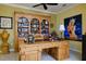 Well-appointed home office with built-in shelving, a ceiling fan, and ample natural light at 3681 Divot Ln, Sarasota, FL 34232