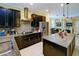 Modern kitchen with dark wood cabinets, granite countertops, and stainless steel appliances, perfect for cooking and entertaining at 3681 Divot Ln, Sarasota, FL 34232