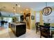 Modern kitchen featuring stainless steel appliances, a large island with granite countertops, and pendant lighting at 3681 Divot Ln, Sarasota, FL 34232
