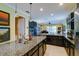 Spacious kitchen boasting granite countertops, dark cabinetry, stainless steel appliances, and ample counter space at 3681 Divot Ln, Sarasota, FL 34232